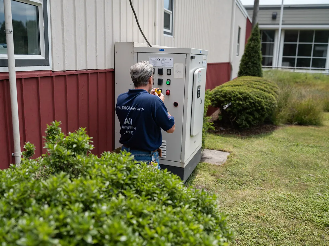 An engineer working at an outdoor electrical distribution cabinet.