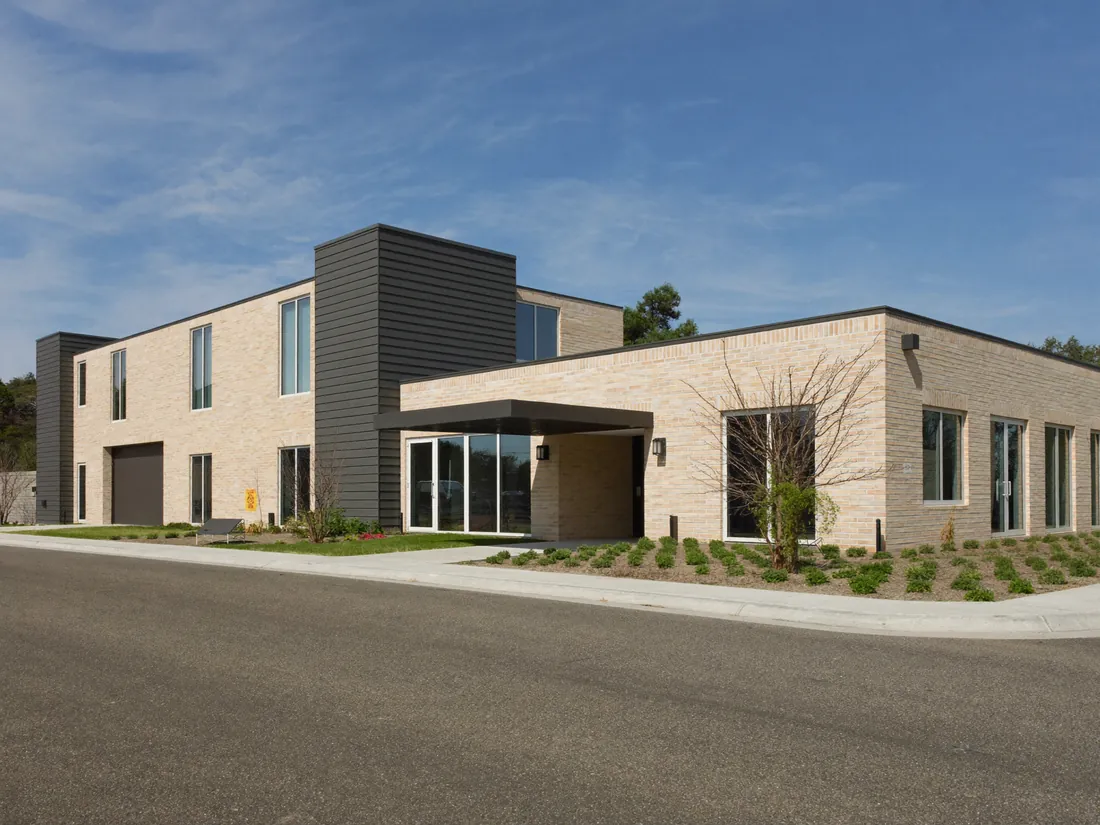 Exterior of a modern single-storey care home and community building.