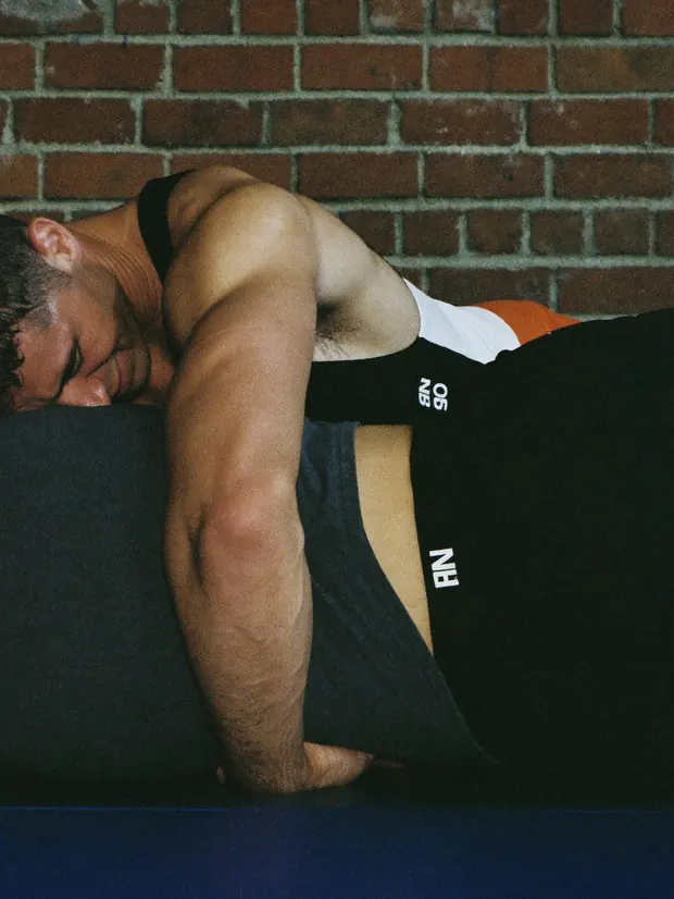 Two men grappling on the mat