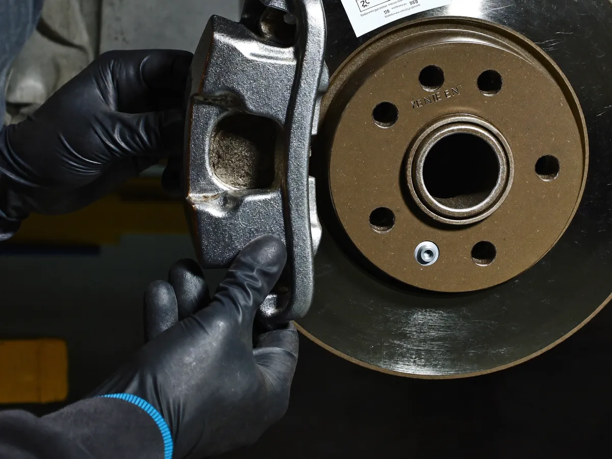 A clean brake disc and caliper with the wheel removed