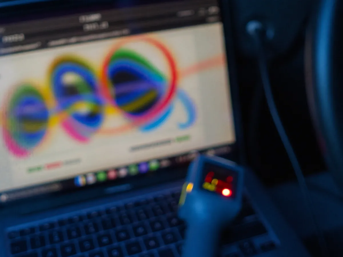 A diagnostic tool plugged into a car's dashboard port