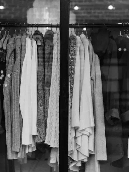 Rail of neutral-toned garments.