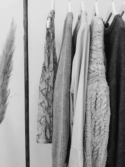 Garments on wooden hangers.