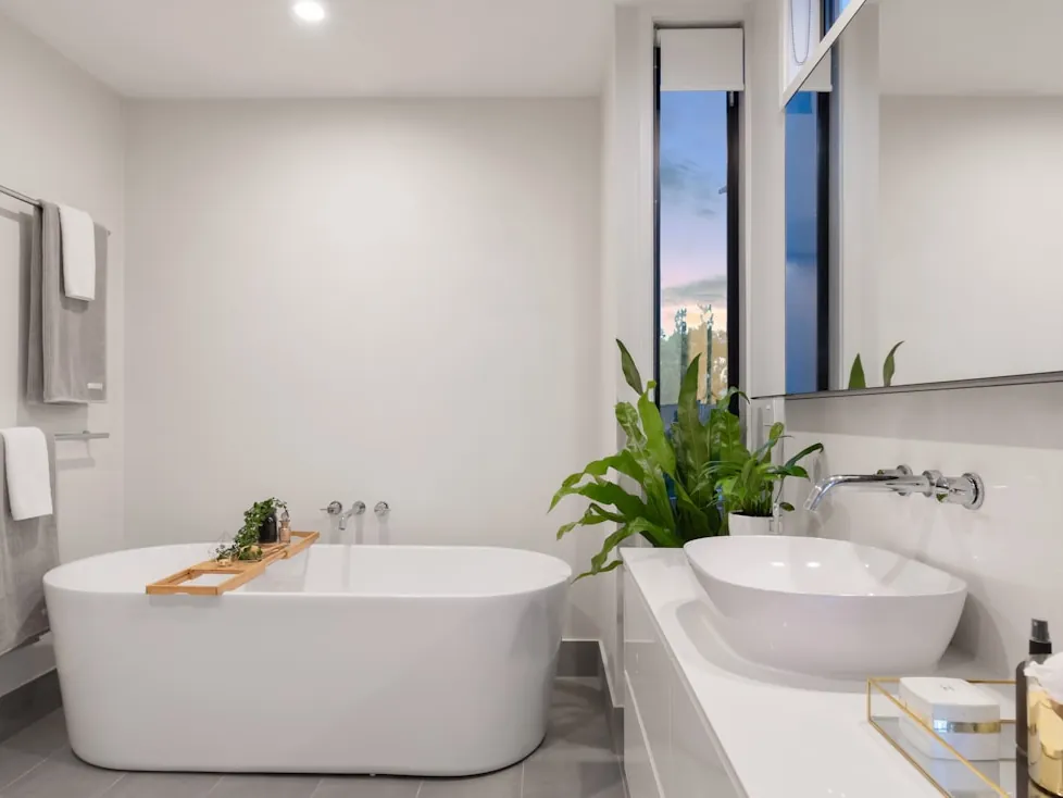 A bathroom with a freestanding bath and twin basins.
