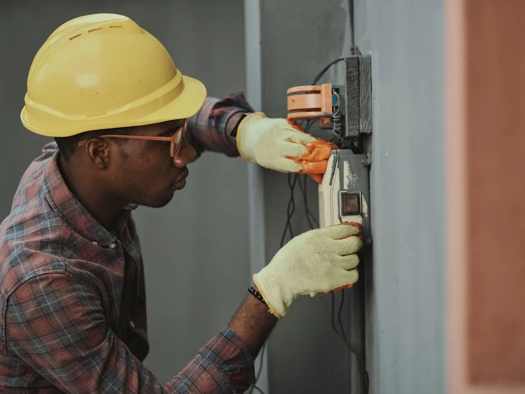 An engineer working on a wall-mounted unit.