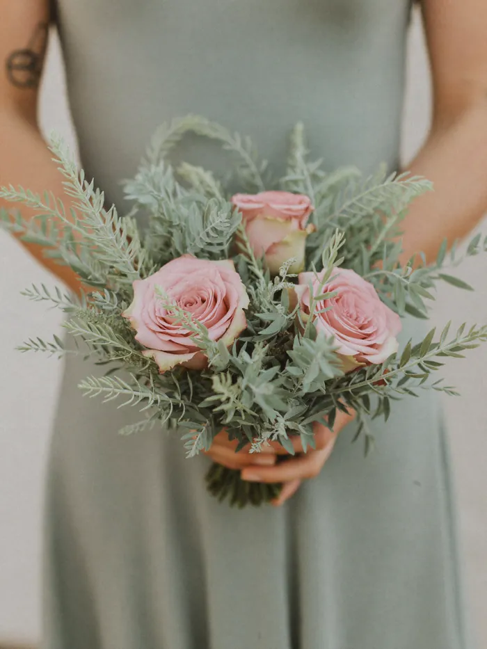 A small bridesmaid posy in sage and dusty pink